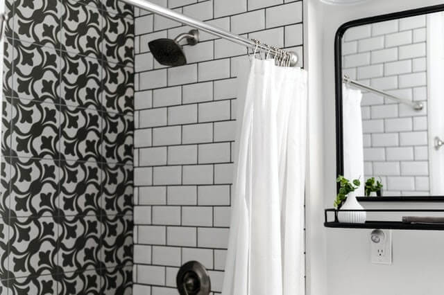 tiled bathroom with a shower and shower curtain