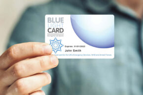 Man holding up a Blue Light Card; Expires: 31/01/2022 - John Smith
