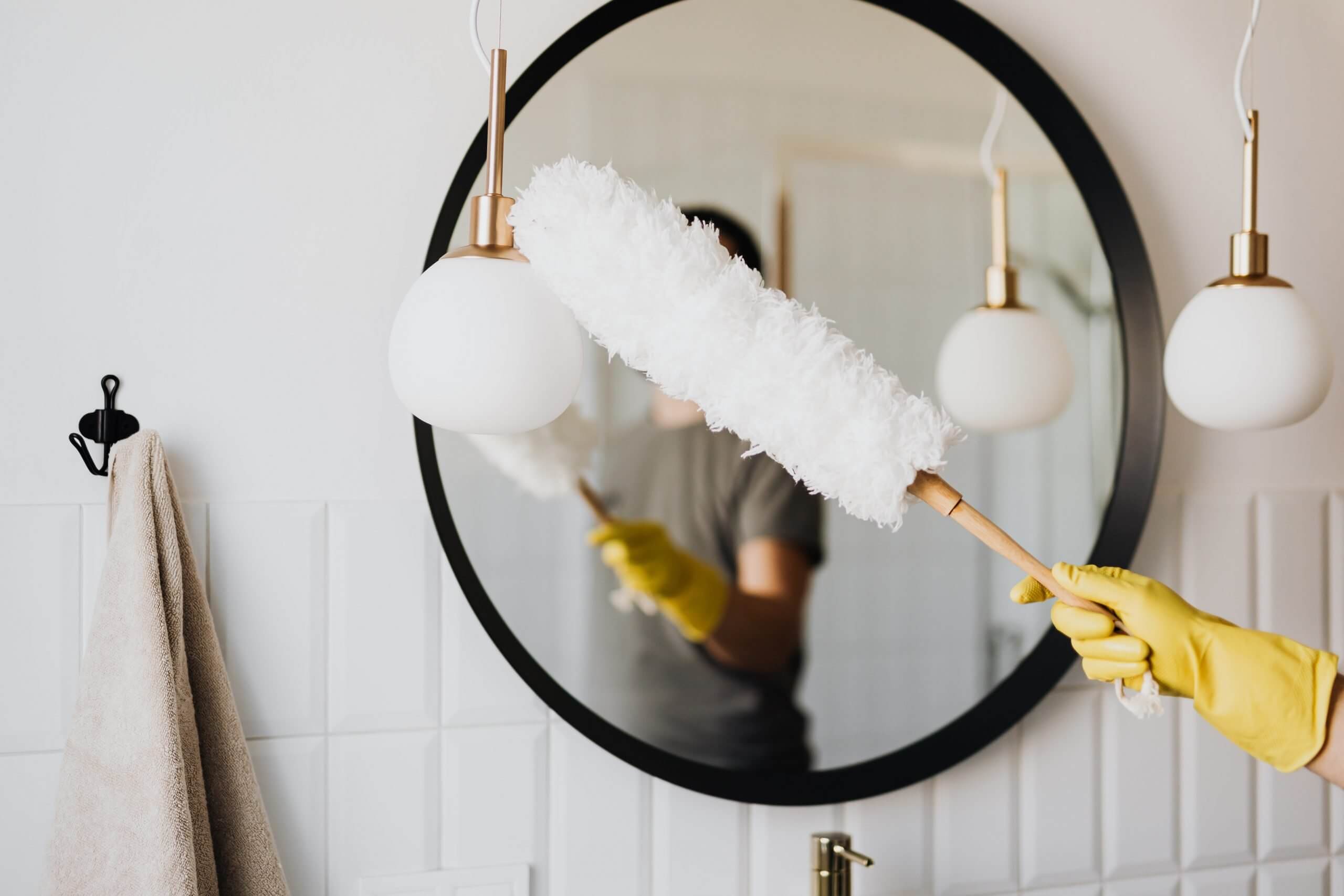 A feather duster cleaning a mirror