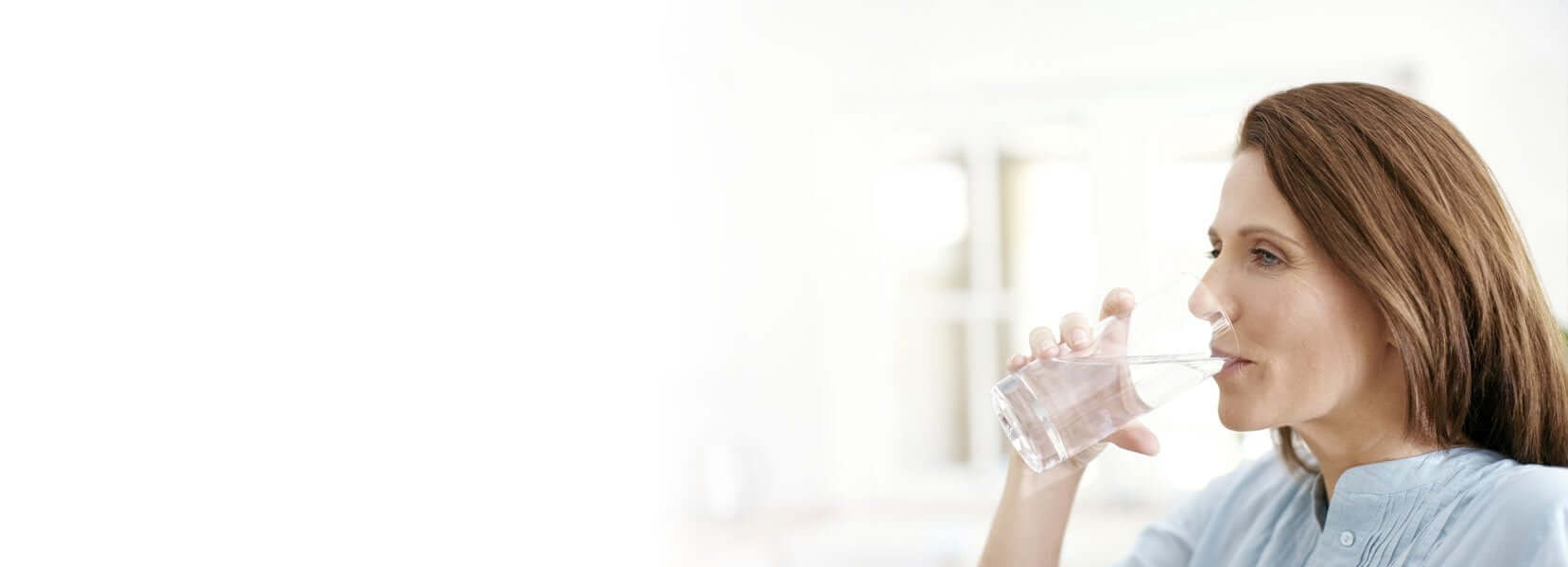 Woman drinking a glass of filtered water