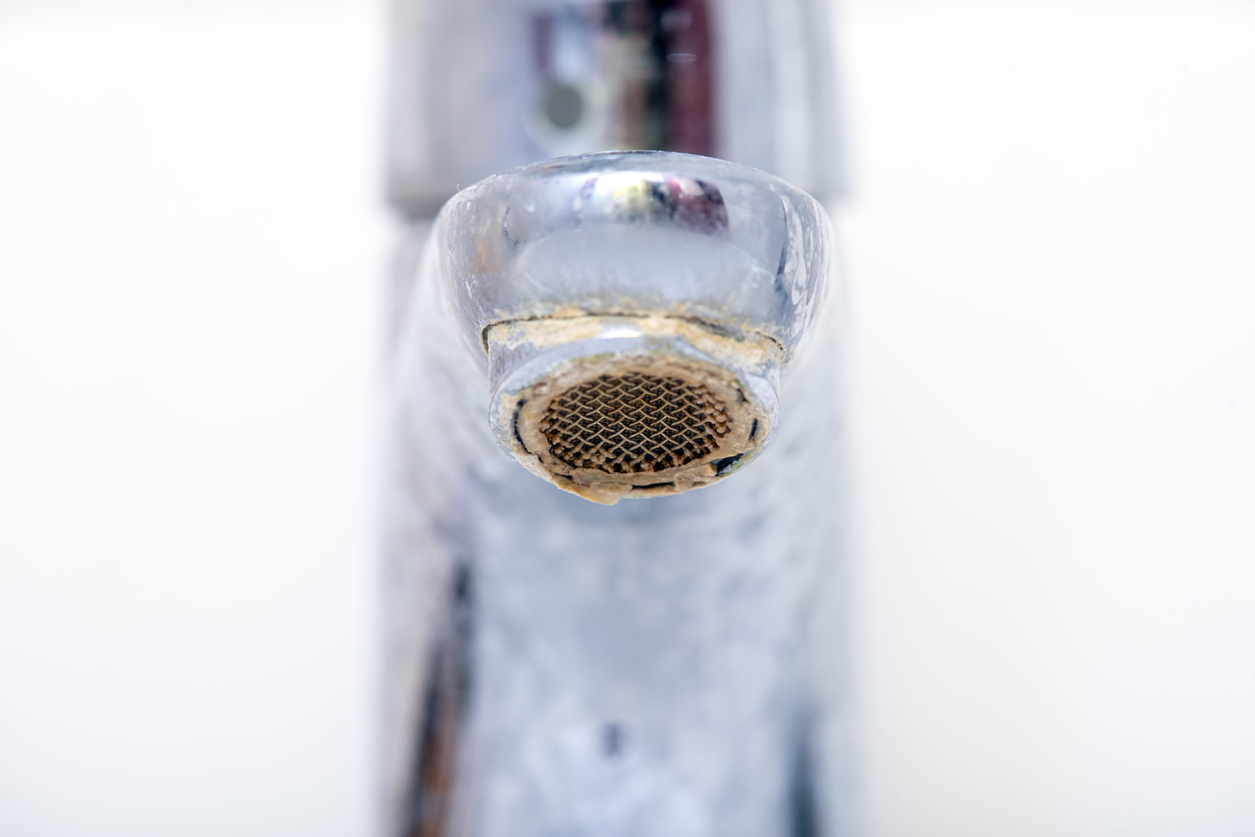 close up of limescale on a tap