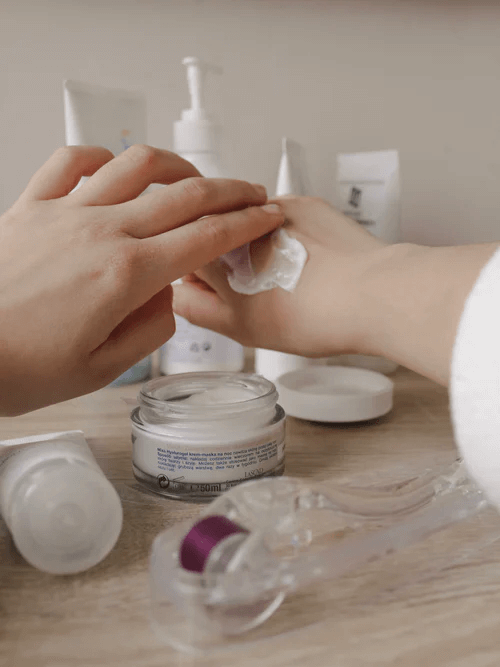 Someone applying moisturiser from the back of their hand