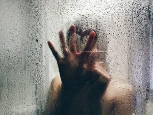hand-on-shower-glass